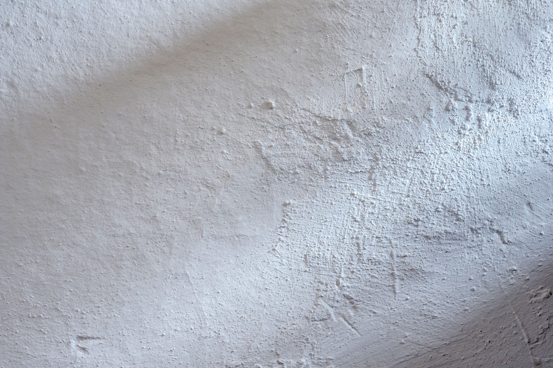 Closeup of an old wall plastered with lime in a rural home. Black and white texture, vintage, grunge, nostalgia.